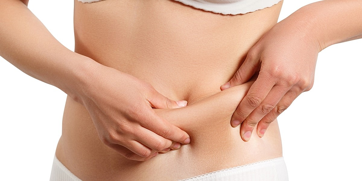 Person pinching skin on abdomen region.