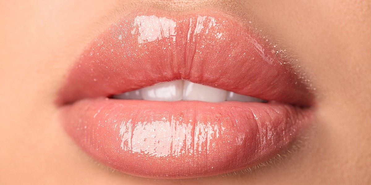 Close-up of glossy, shimmering lips.