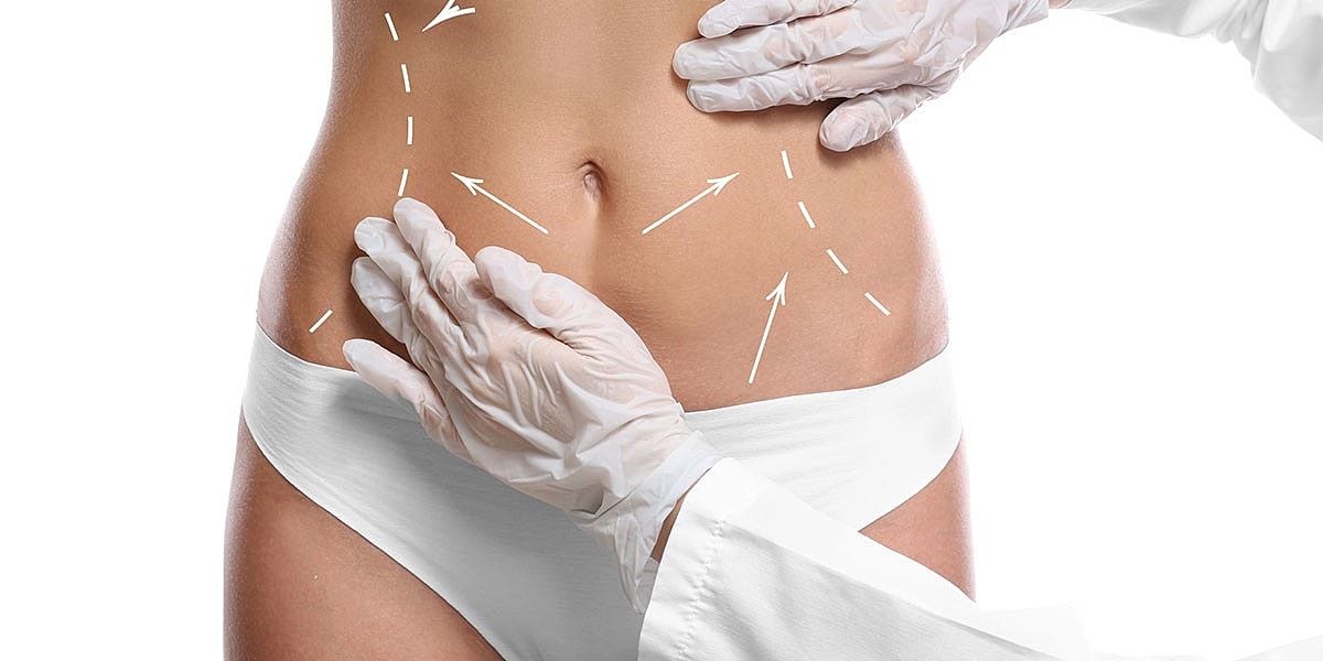 Medical professional examining a woman's abdomen.