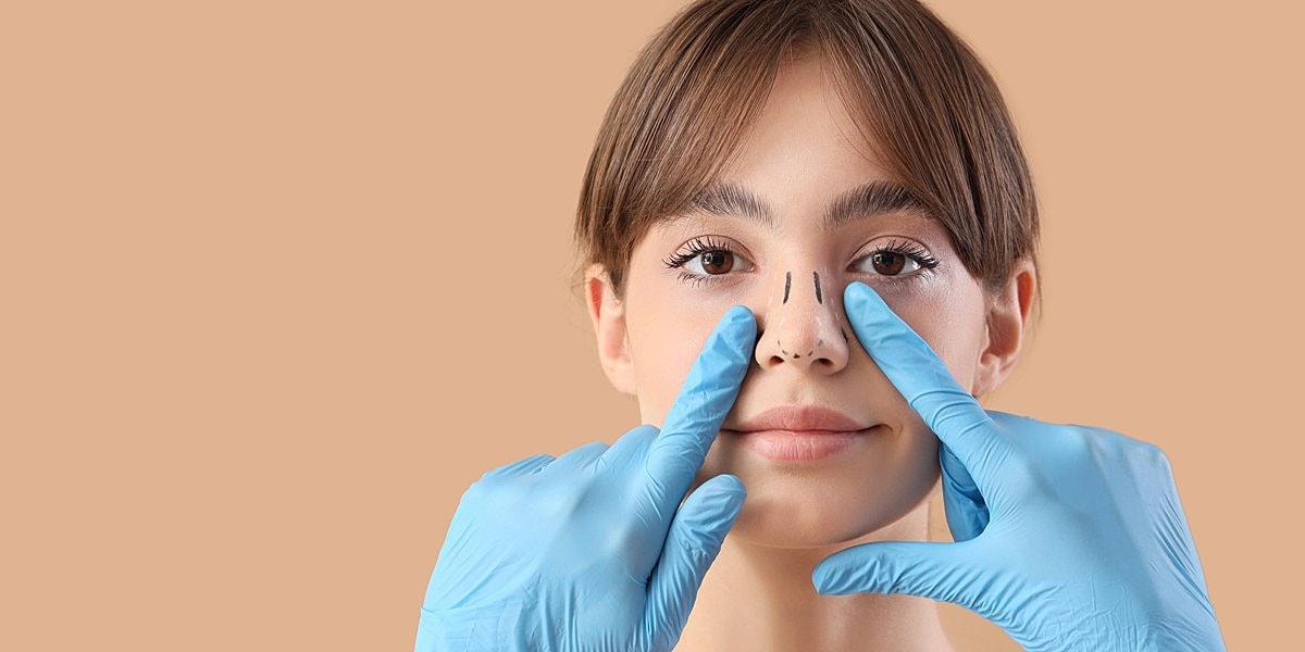 Medical professional demonstrating nose procedure on patient.