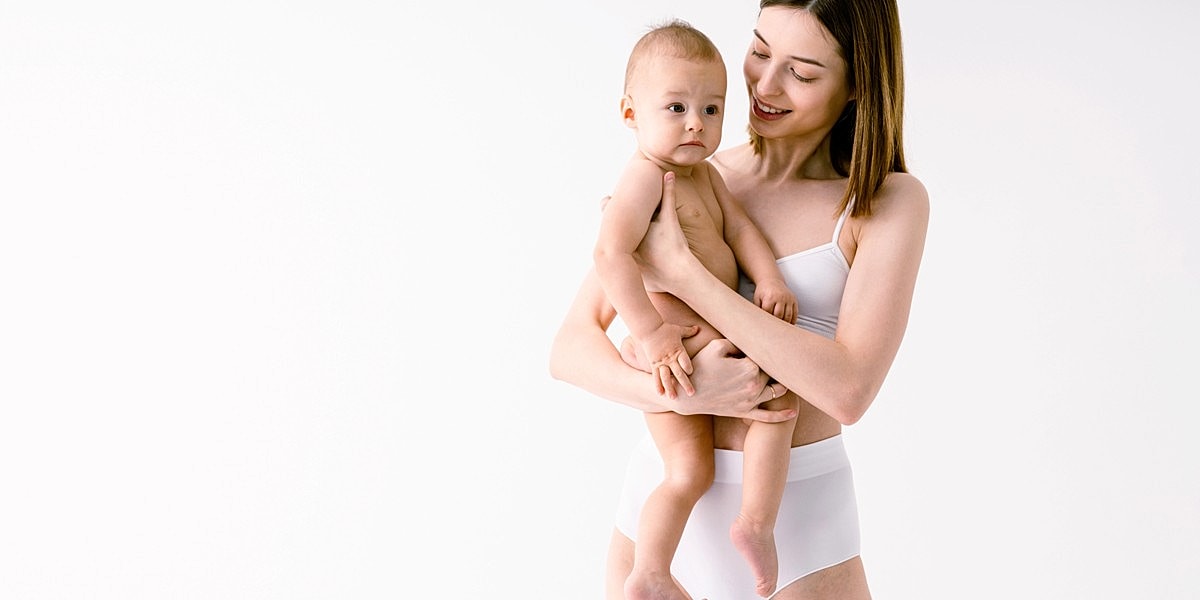Mother holding baby in white background.