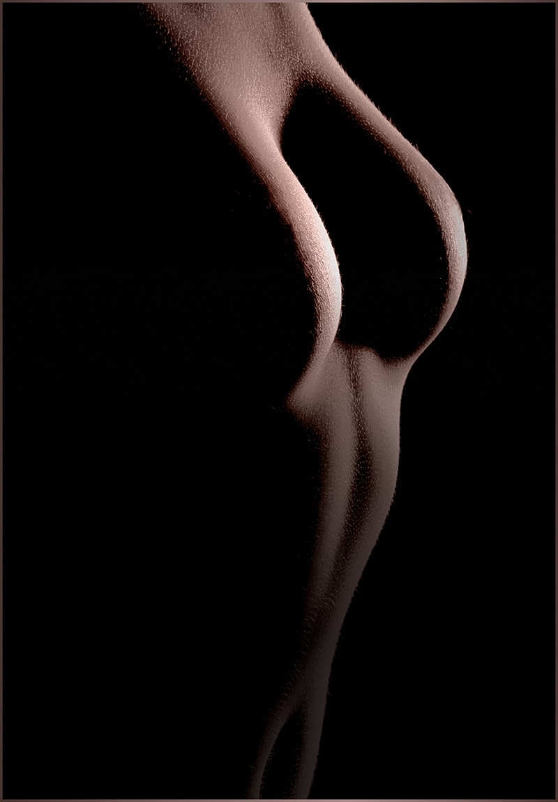 Silhouette of a woman's upper body in shadows