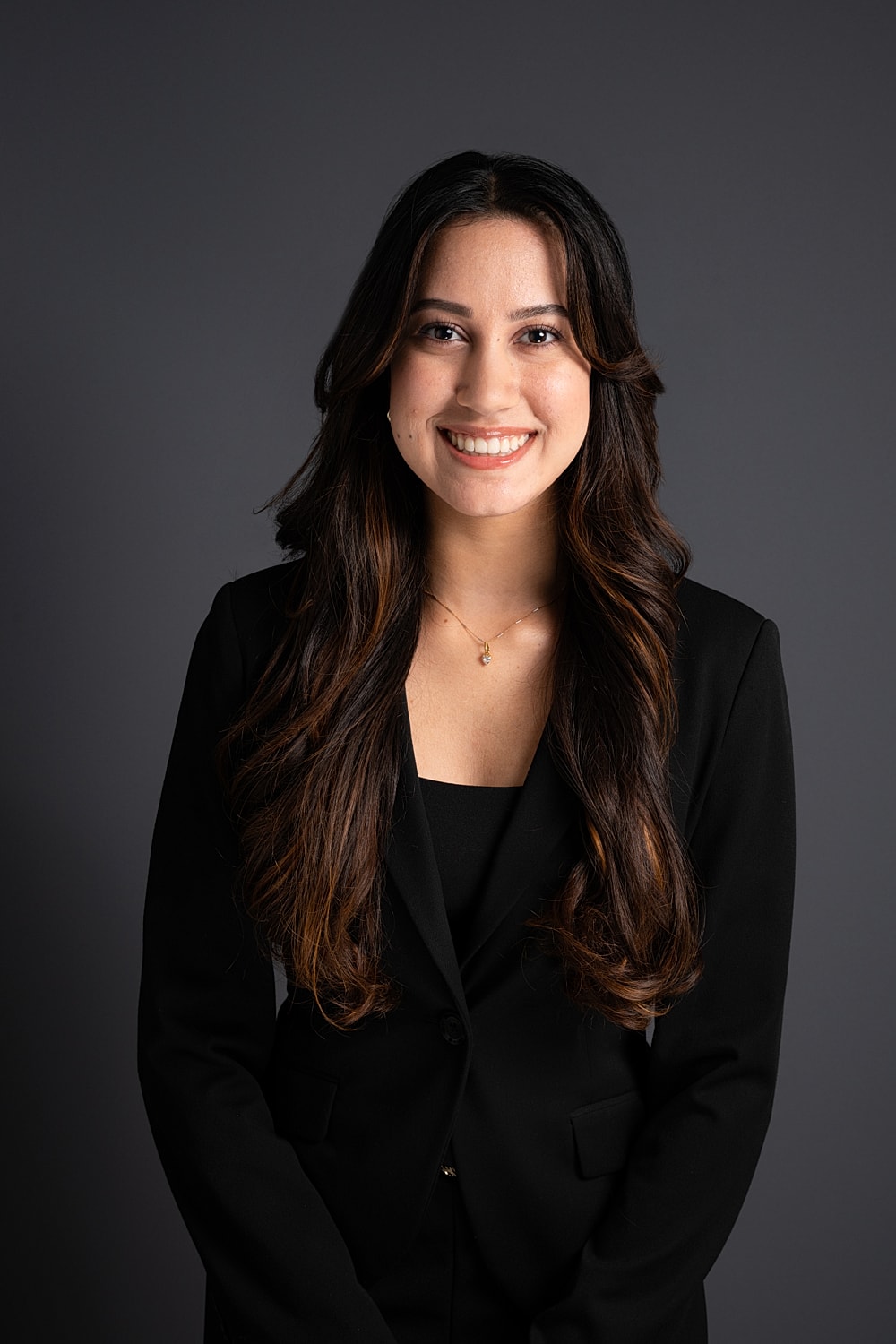 Smiling woman in formal black attire portrait.