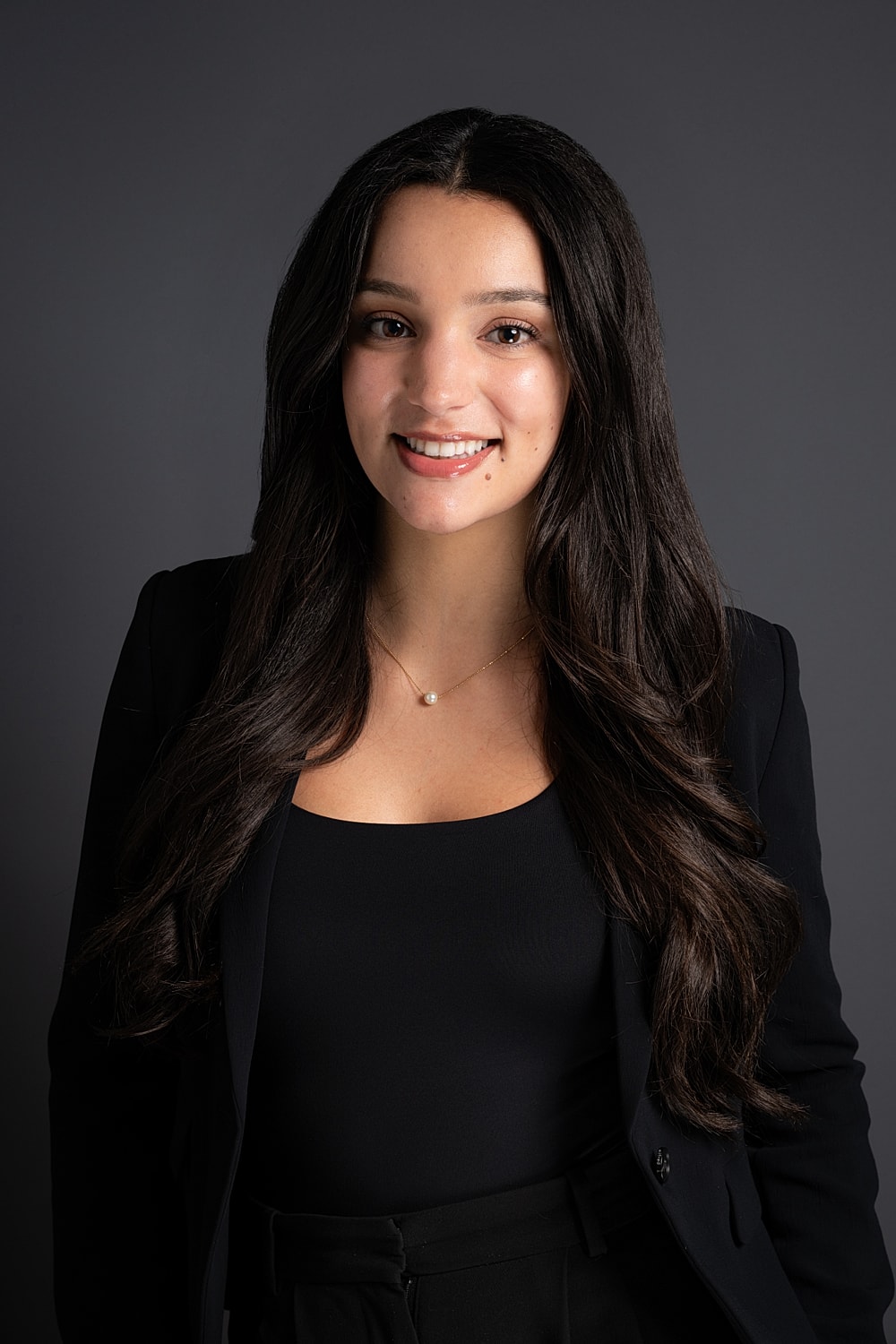 Professional portrait of a young woman smiling.