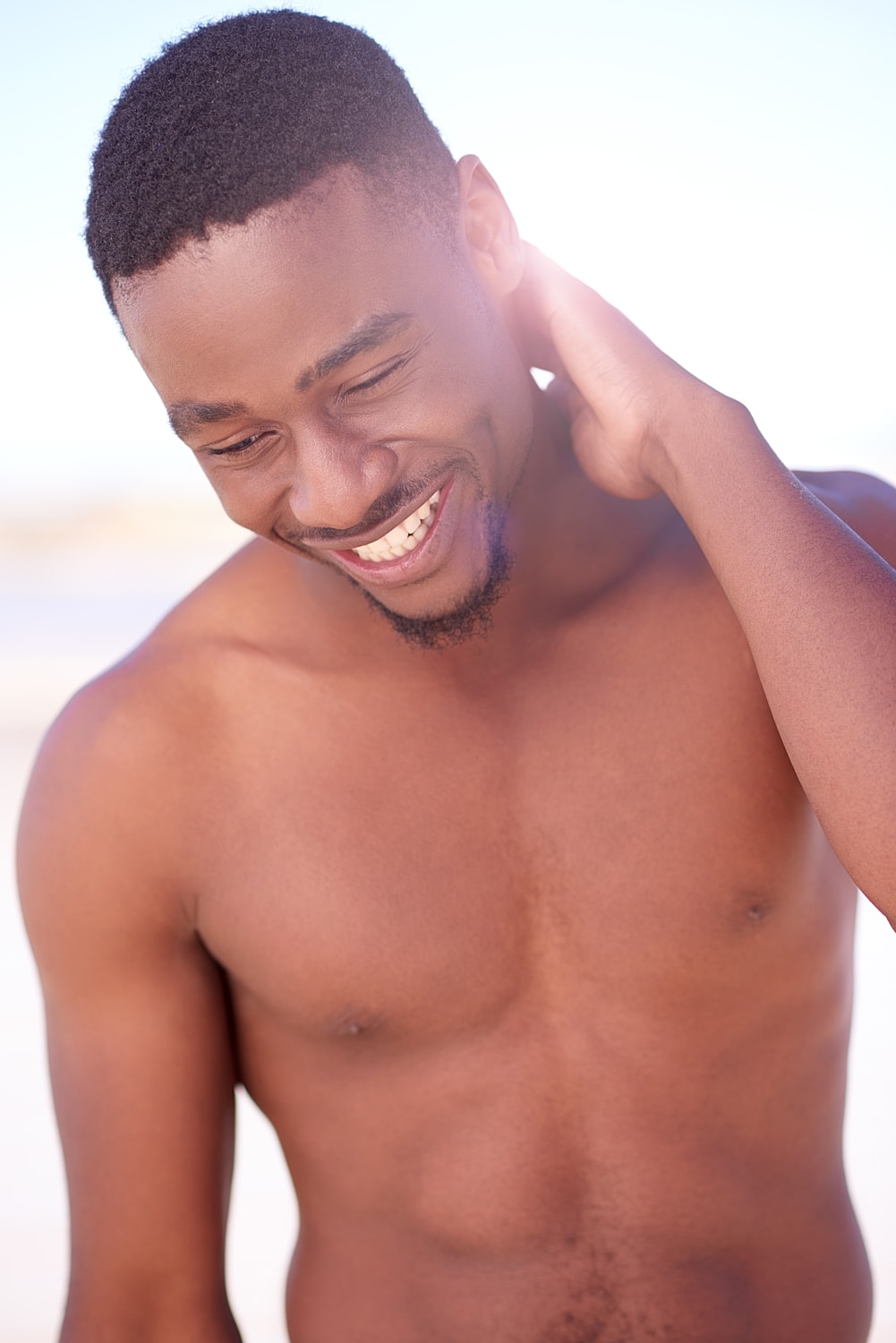 NYC keloid scar removal model with short hair, natural lighting.