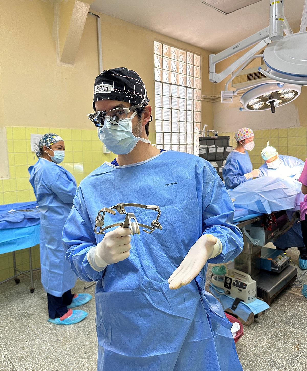 Surgeons preparing for a procedure in operating room.